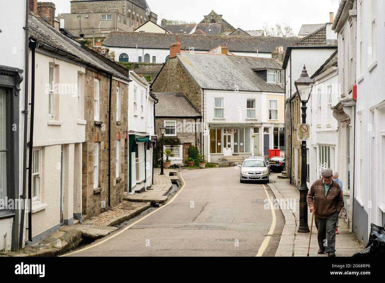 Around Helston, a small Cornish town. Old man walking up church st Stock Photo
