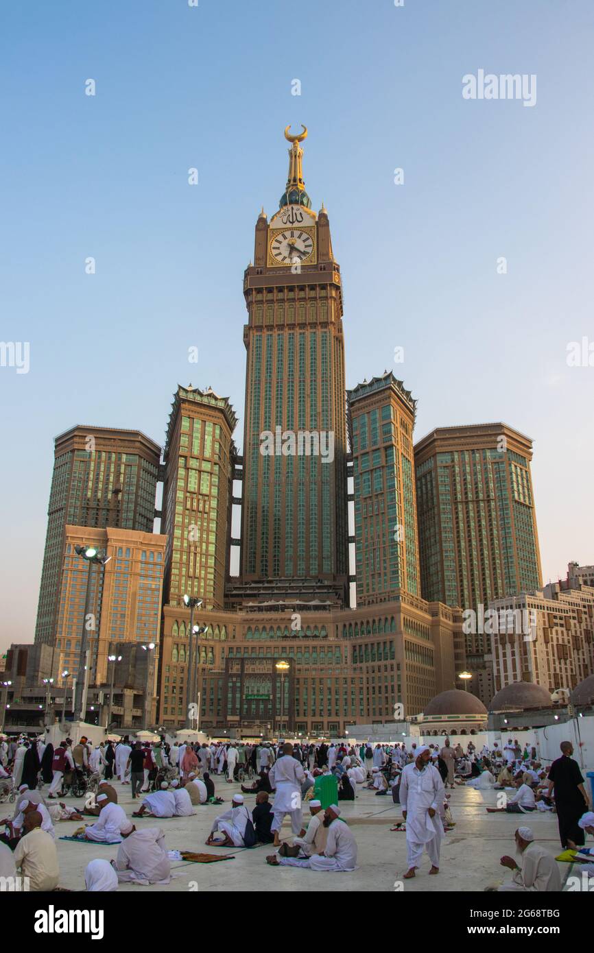 Abraj Al Bait Tower in Mecca, Saudi Arabia. Royal Clock Tower, blue sky scenery and pilgrims from around the world Stock Photo
