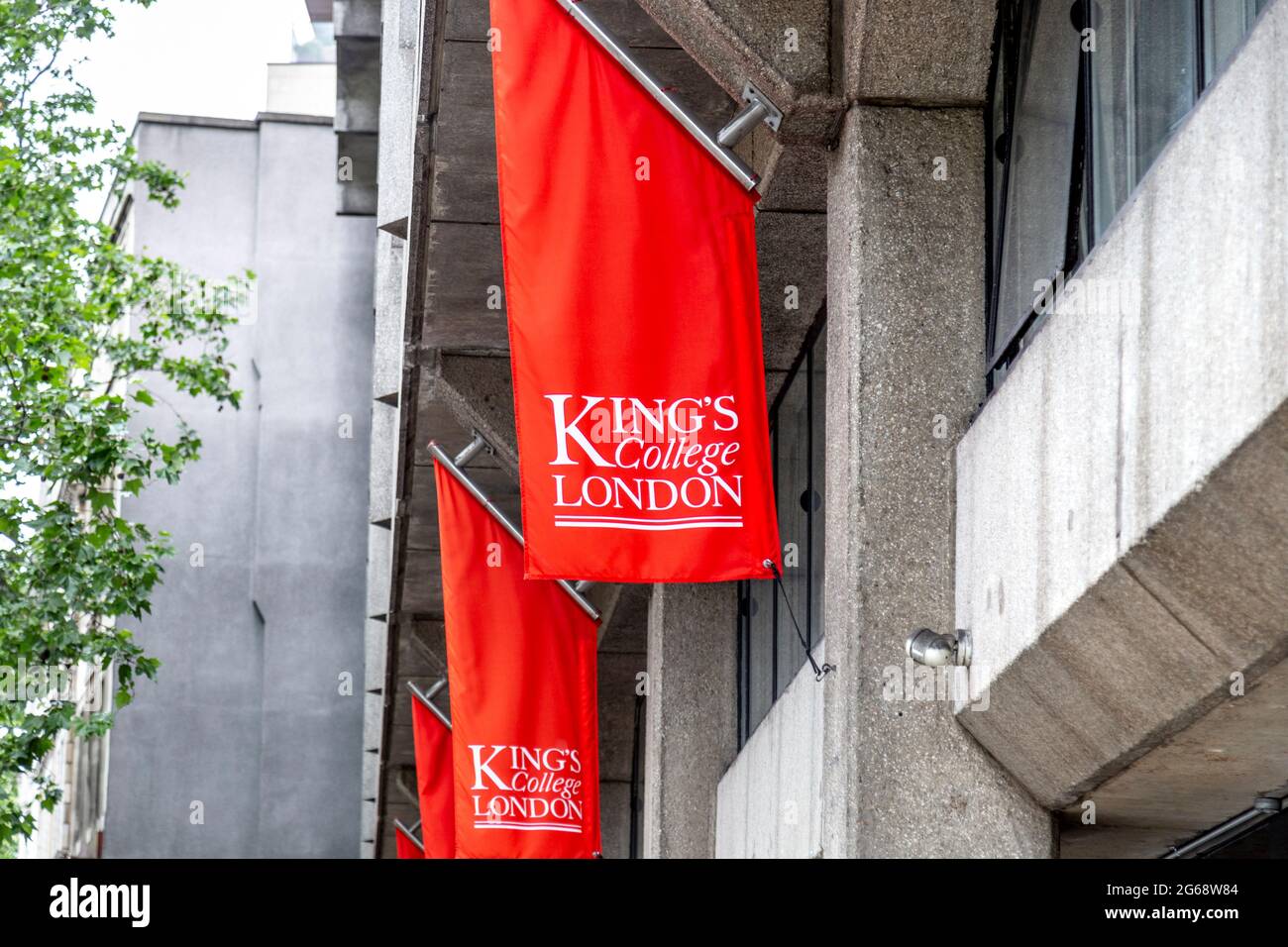 Red flags on the brutalist facade of the Kings College Macadam Building, Strand Campus, Temple, London, UK Stock Photo