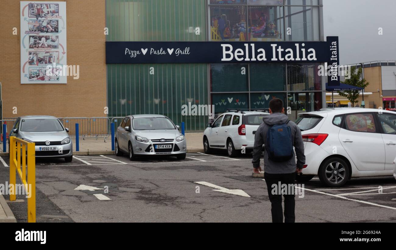View of a man walking towards Bella Italia Restaurant at Festival Leisure Park, Basildon, Essex, UK Stock Photo
