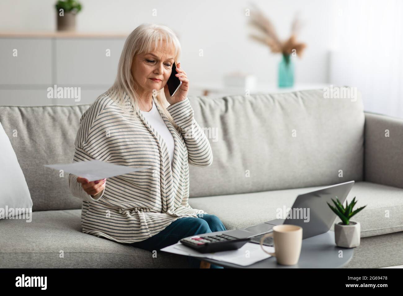 Woman paperwork home mature hi-res stock photography and images - Alamy