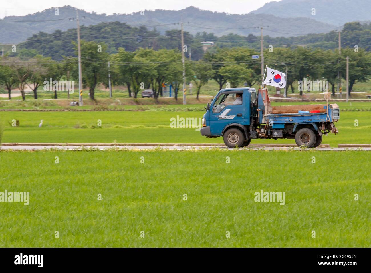 July 4, 2021-Sangju, South Korea-Farmer look their farm field on monsoon season in South Korea. Monsoon rains are likely to hit most parts of the country this weekend, marking the start of the one-month summer rainy season, the state weather agency said Thursday. The Korea Meteorological Administration (KMA) said heavy rains will fall on the southern island of Jeju on Saturday morning and spread to southern and central regions between late Saturday and Sunday. Stock Photo