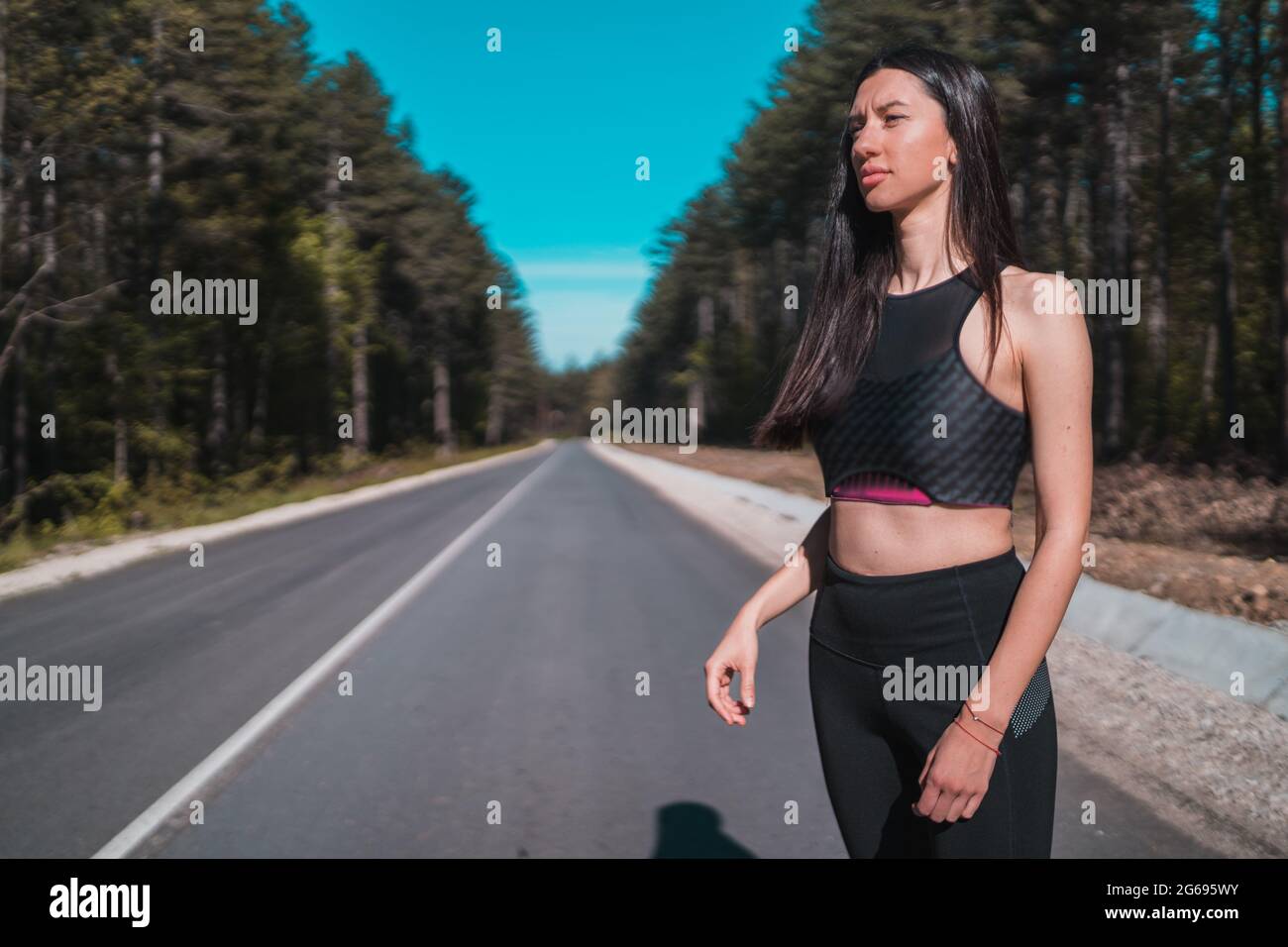 Fit girl in black outfit preparing for jogging in the morning Stock Photo