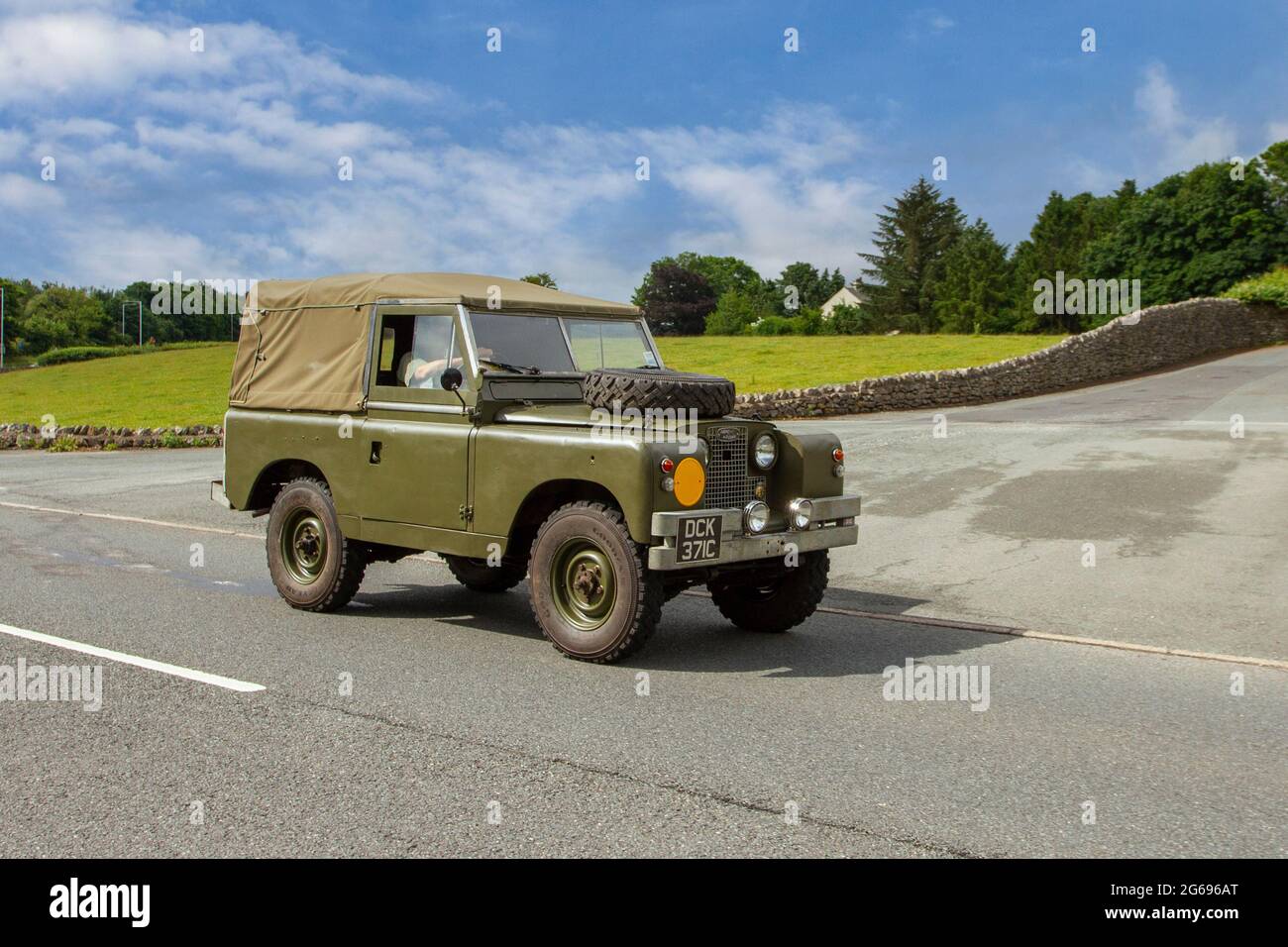 1965 60s sixties canvas top Green Series IIA Land Rover 2495 cc diesel 2dr pick-up en-route to Leighton Hall veteran classic car July car show, Carnforth, Lancashire UK Stock Photo