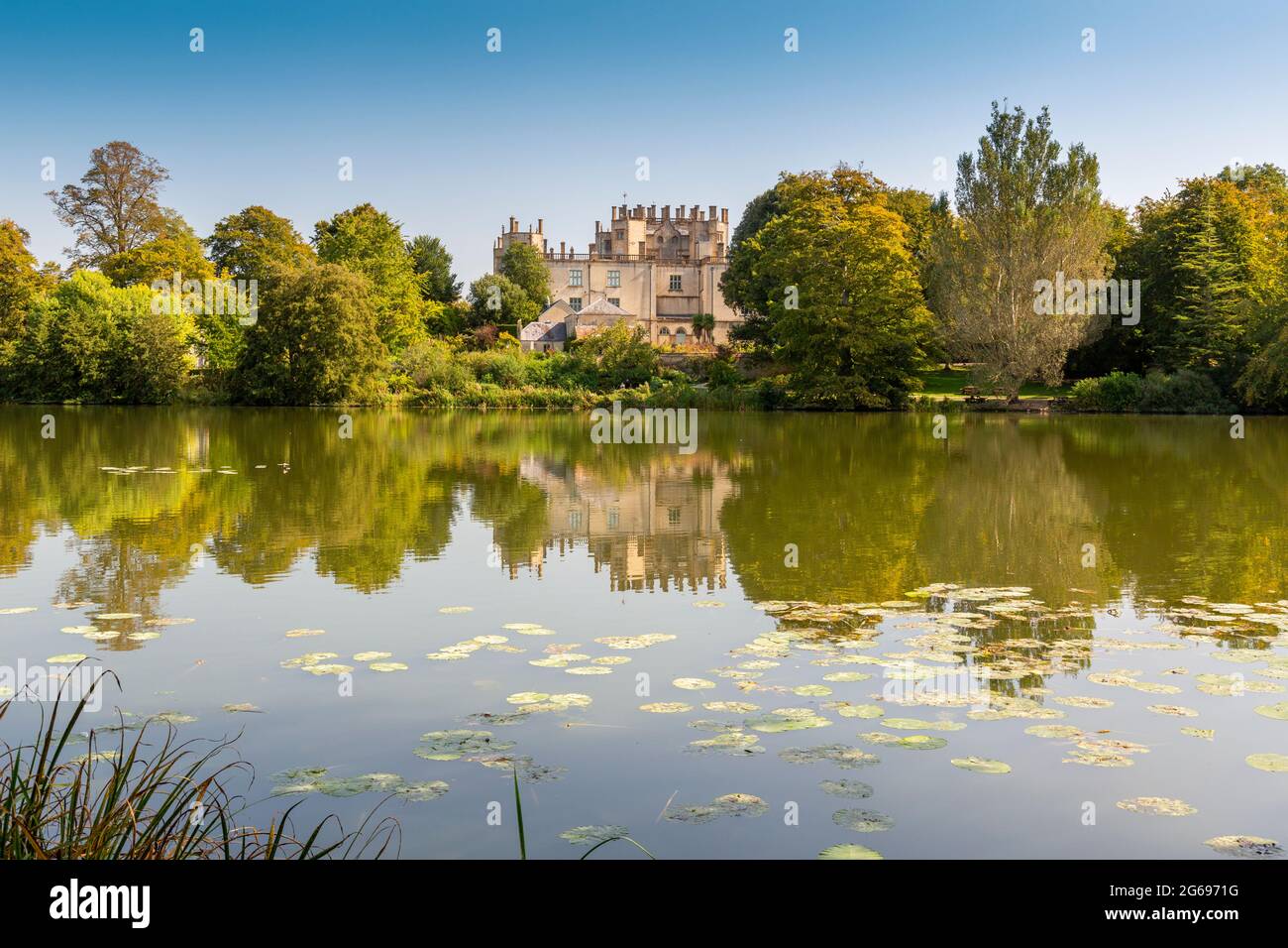 The view across the ornamental lake created by Capability Brown towards Sherborne Castle, Dorset, England, UK Stock Photo