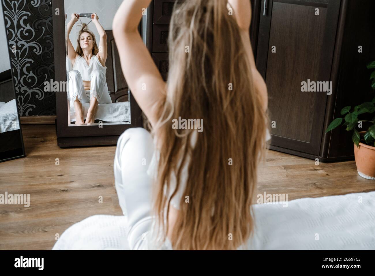 Mental health, mental wellbeing, calm, mourning routines, start day. No stress, healthy habit, concept. Young woman in pajamas waking up in morning Stock Photo