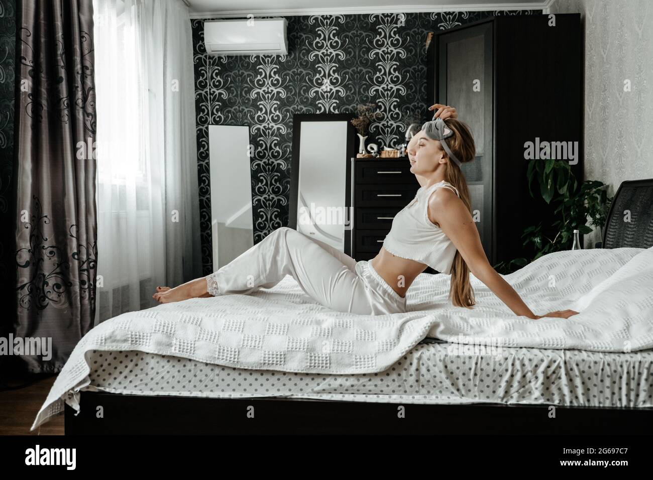 Mental health, mental wellbeing, calm, mourning routines, start day. No stress, healthy habit, concept. Young woman in pajamas waking up in morning Stock Photo
