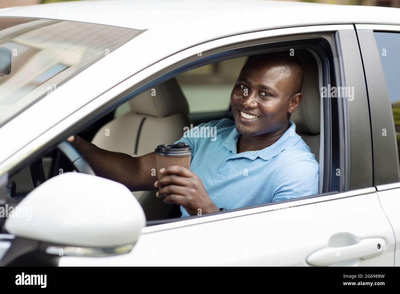 Smiling african american man driver drinking coffee Stock Photo Alamy