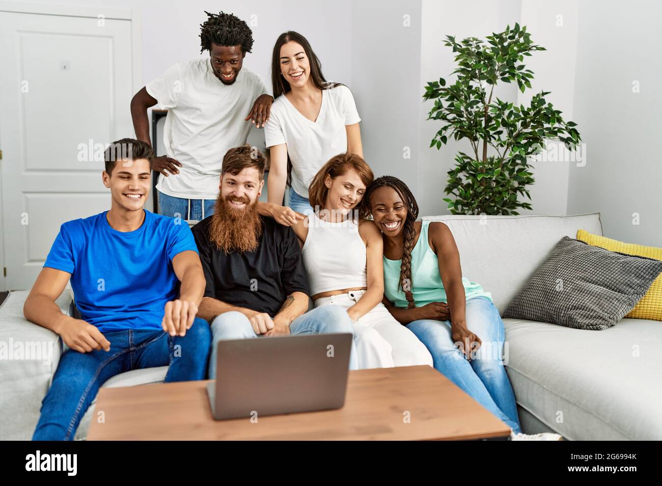 Group of young friends smiling happy having video call using laptop at ...