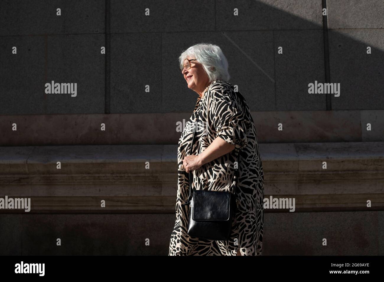 Older woman walking street hi-res stock photography and images - Alamy