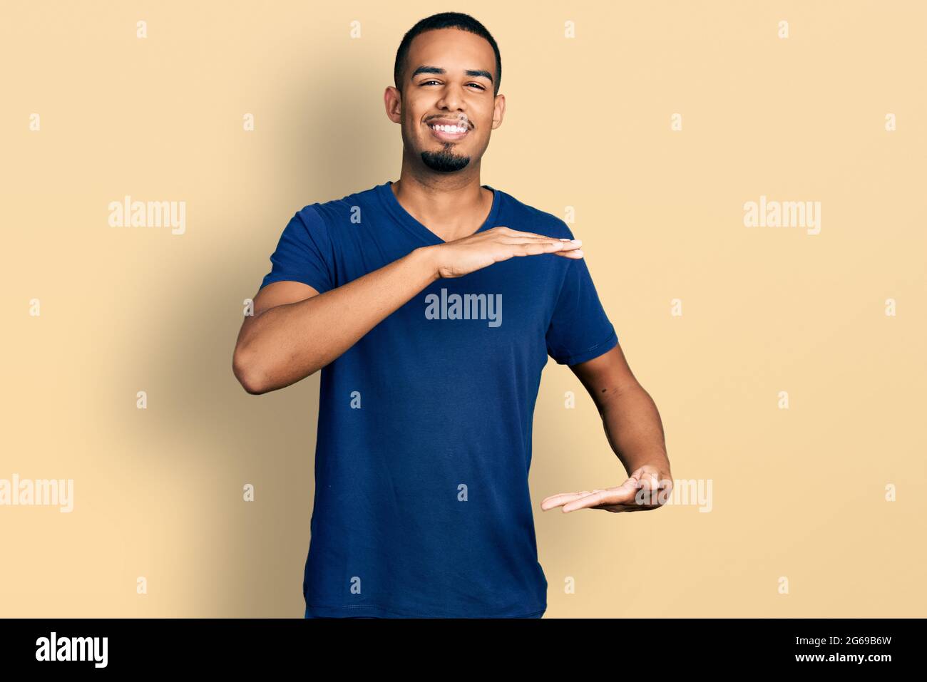 Young plus size woman wearing casual clothes gesturing with hands showing  big and large size sign, measure symbol. smiling looking at the camera.  meas Stock Photo - Alamy