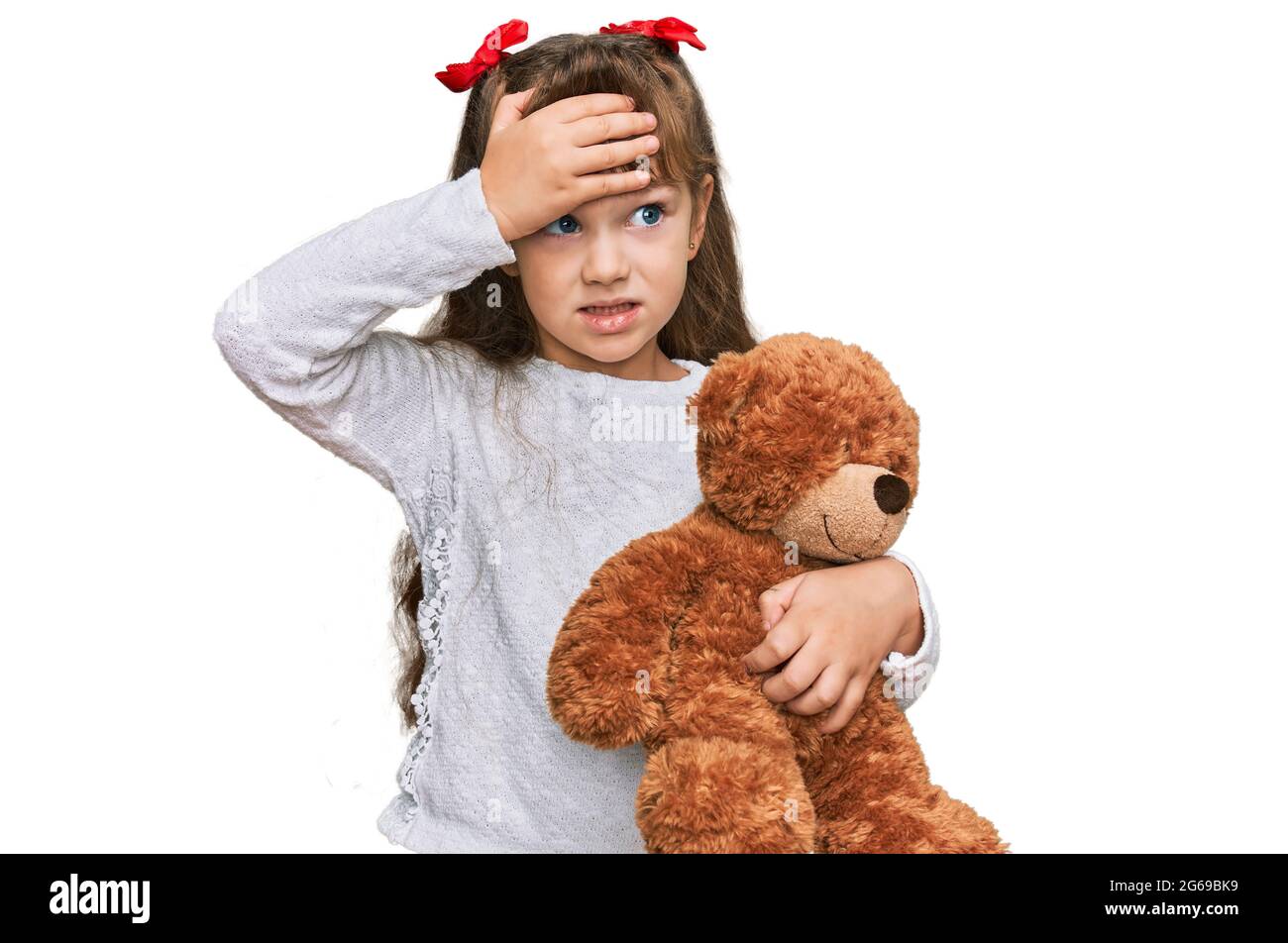 Little caucasian girl kid hugging teddy bear stuffed animal