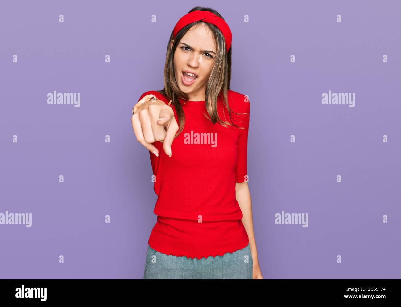 Young brunette woman wearing casual clothes pointing displeased and ...