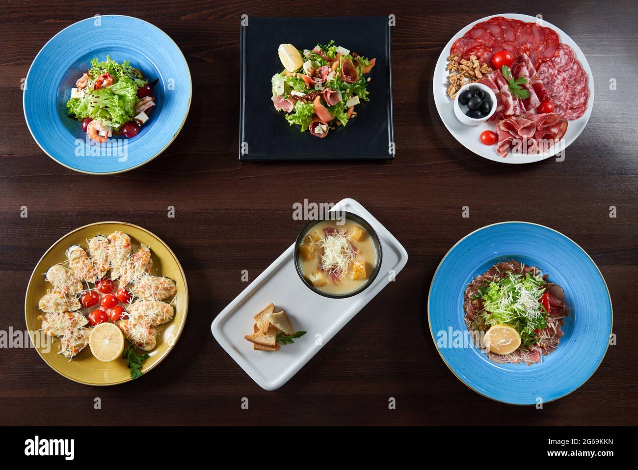 Restaurant table full of delicious food Stock Photo - Alamy