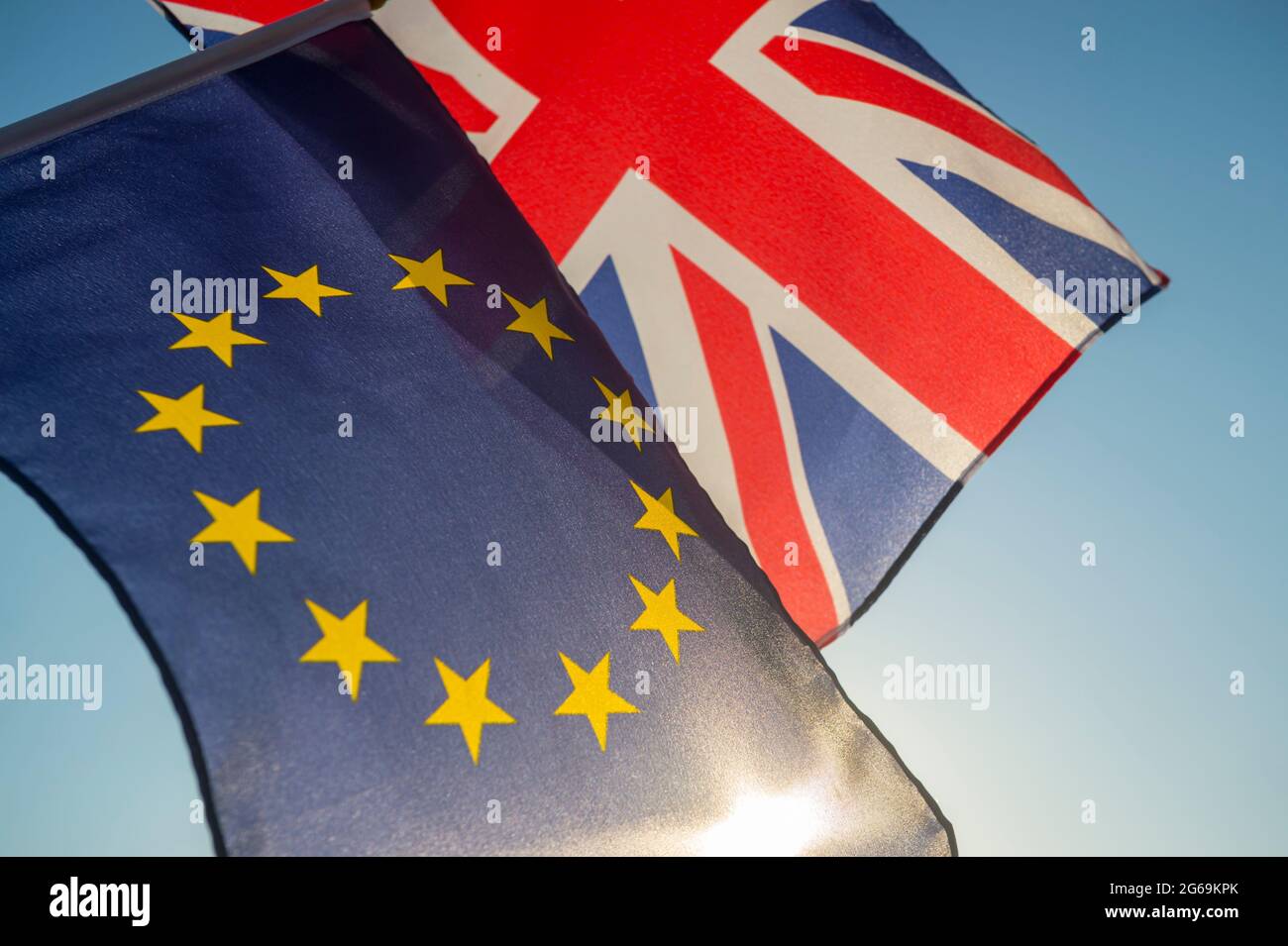 European Union and British Union Jack flag flying together in front of bright blue sky Stock Photo