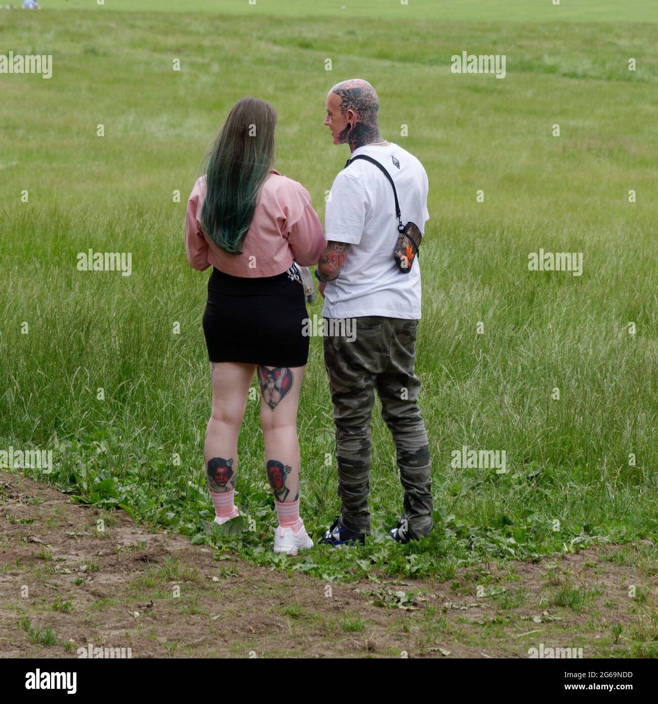 London, Greater London, England - June 26 2021: Couple with leg and or head tattoo's. Stock Photo