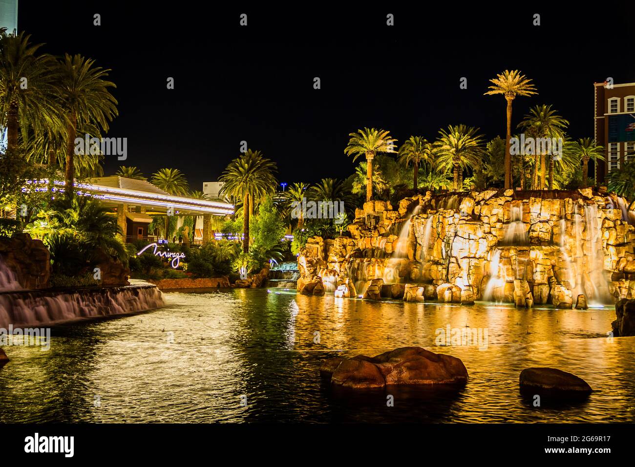The pool with palm trees of the Mirage at night Stock Photo