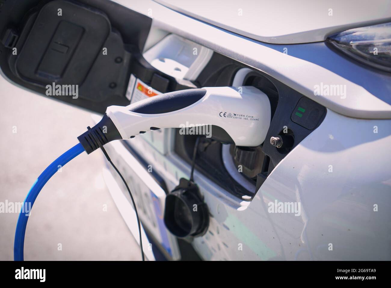 Electric car charging its battery with natural landscape, for green