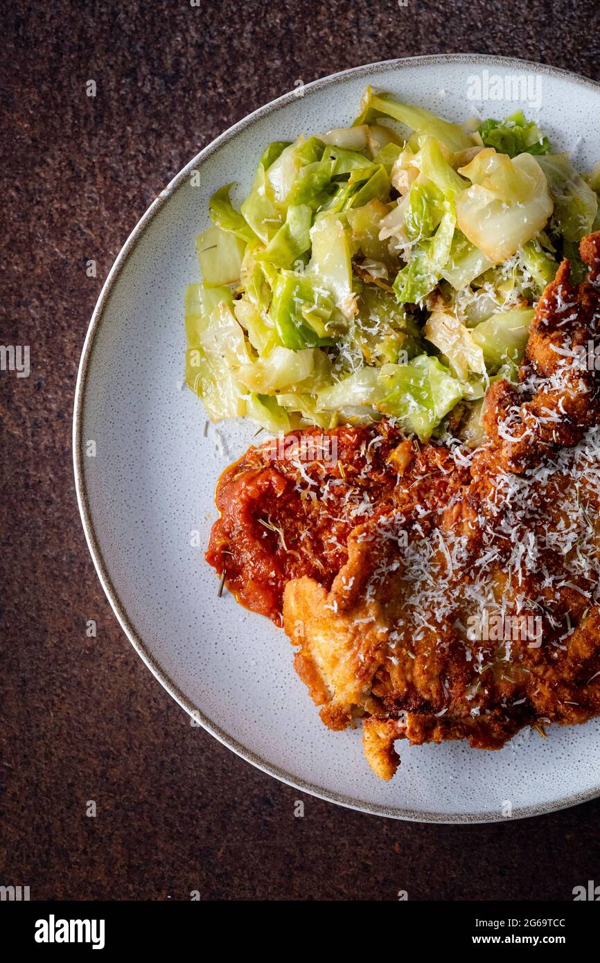 Turkey steak milanese with sautéed cabbage Stock Photo - Alamy