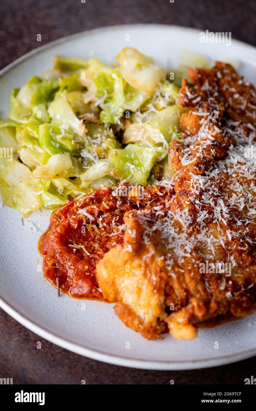 Turkey steak milanese with sautéed cabbage Stock Photo - Alamy