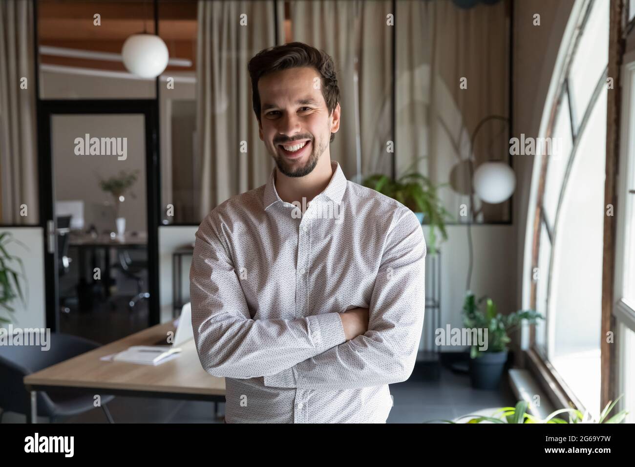 Head shot portrait of smiling businessman with arms crossed Stock Photo ...