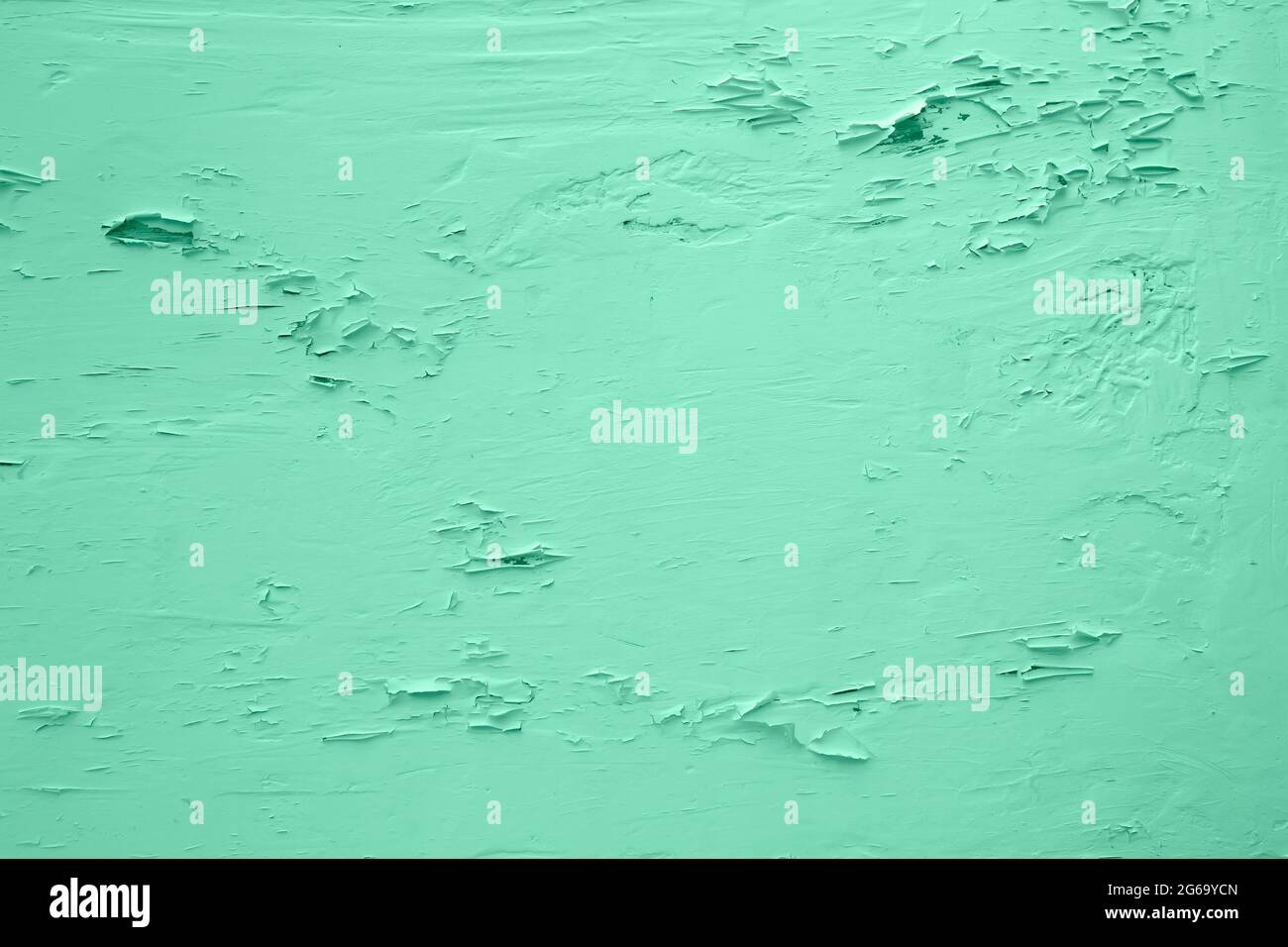Pale green wall with peeling plaster Stock Photo