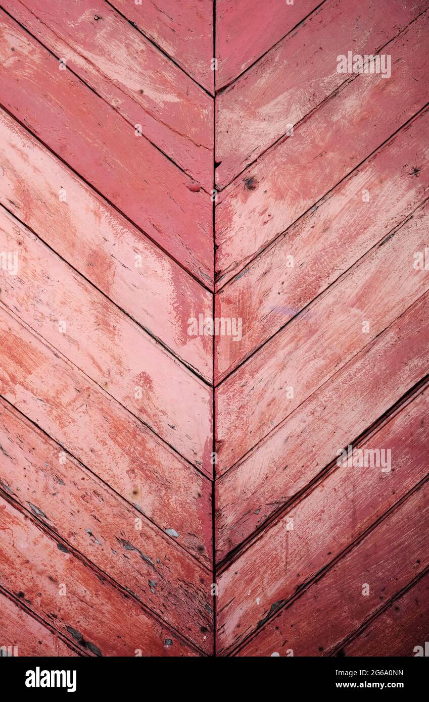 Old distressed pink wooden wall with diagonal strips, rustic background or texture Stock Photo
