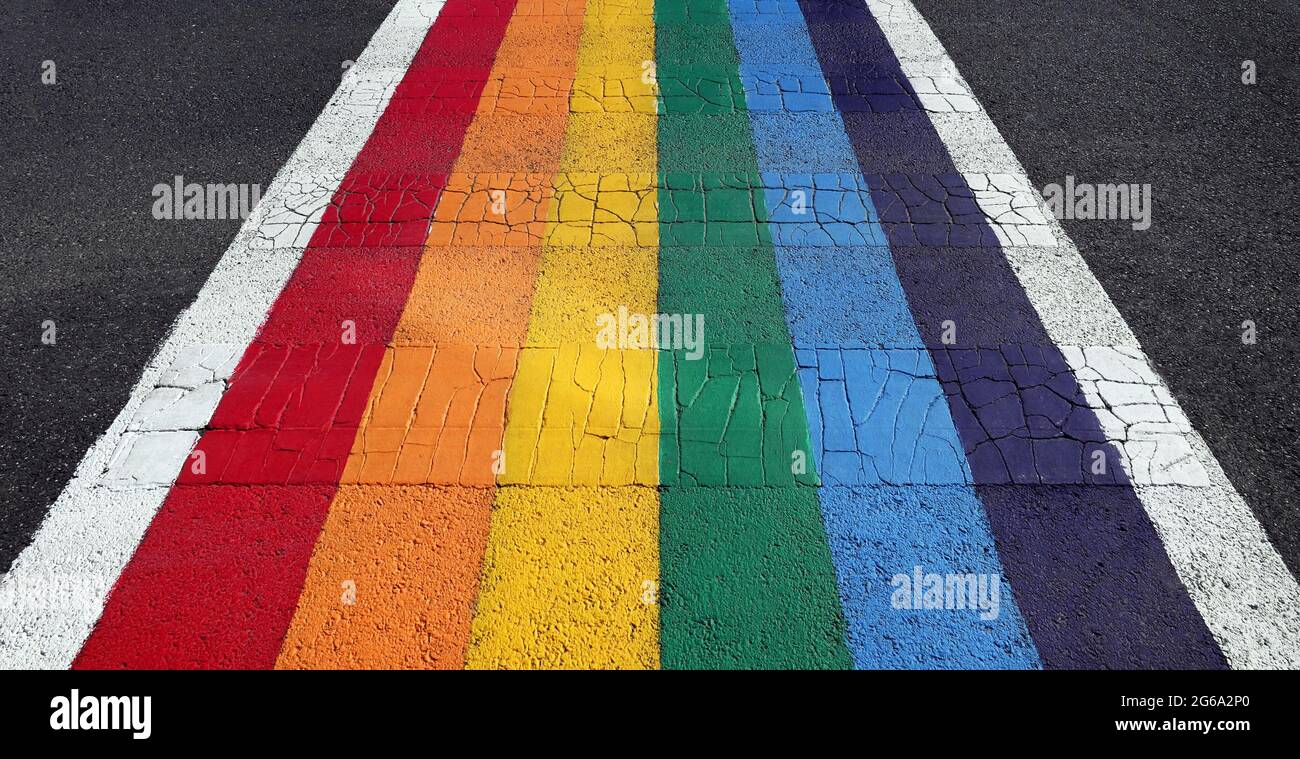 A crosswalk painted in rainbow colors for Pride Month. Stock Photo