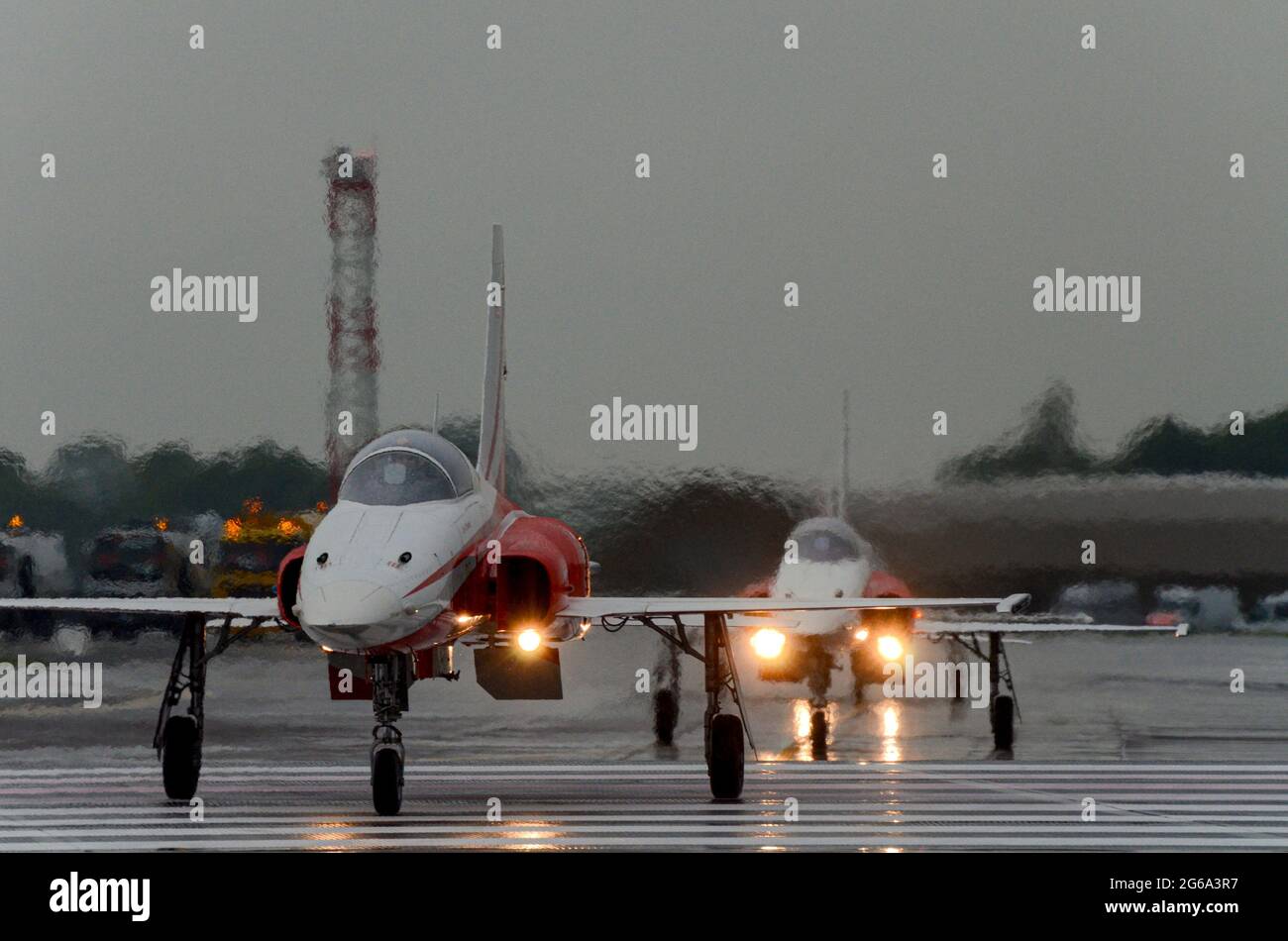 Patrouille Suisse, Swiss display team fighter jet planes arriving at the Royal International Air Tattoo, UK, in typical English summer rain weather Stock Photo