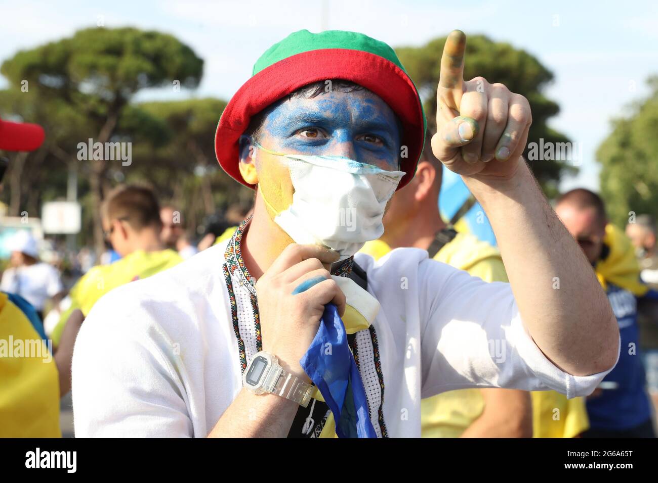 Rome, Italy, 3rd July 2021. A Ukraine fan with his face painted makes friendly gestures towards England fans prior to the UEFA Euro 2020 Quarter Final match at the Stadio Olimpico, Rome. Picture credit should read: Jonathan Moscrop / Sportimage Stock Photo