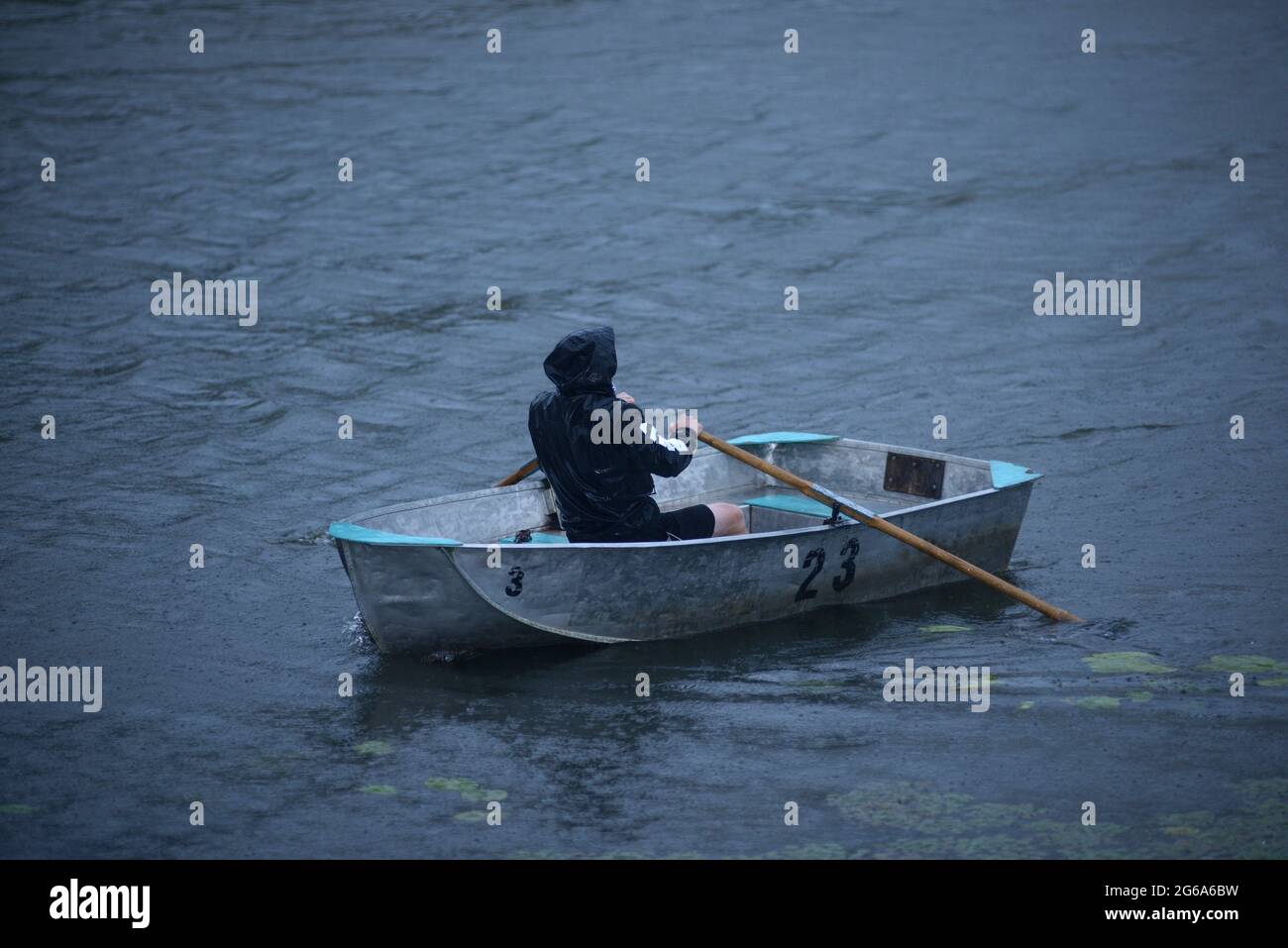 Man rowing boat rain hi res stock photography and images Alamy