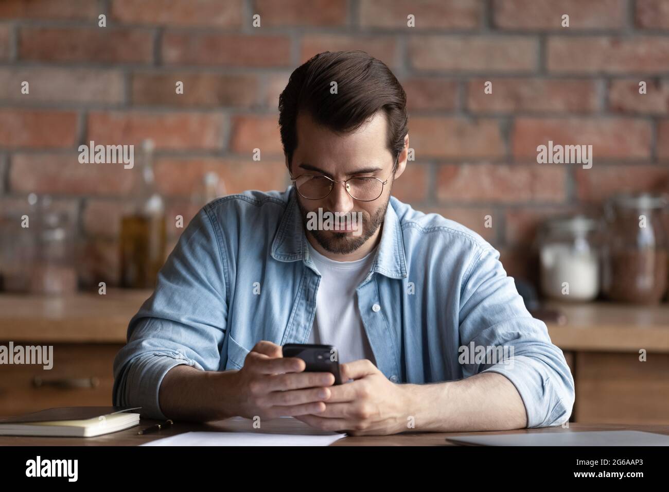 Focused man using mobile service, online app on smartphone Stock Photo