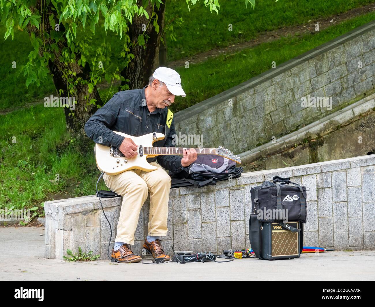 Bucharest, Romania - 06.04.2021: Senior street artist musician sitting ...
