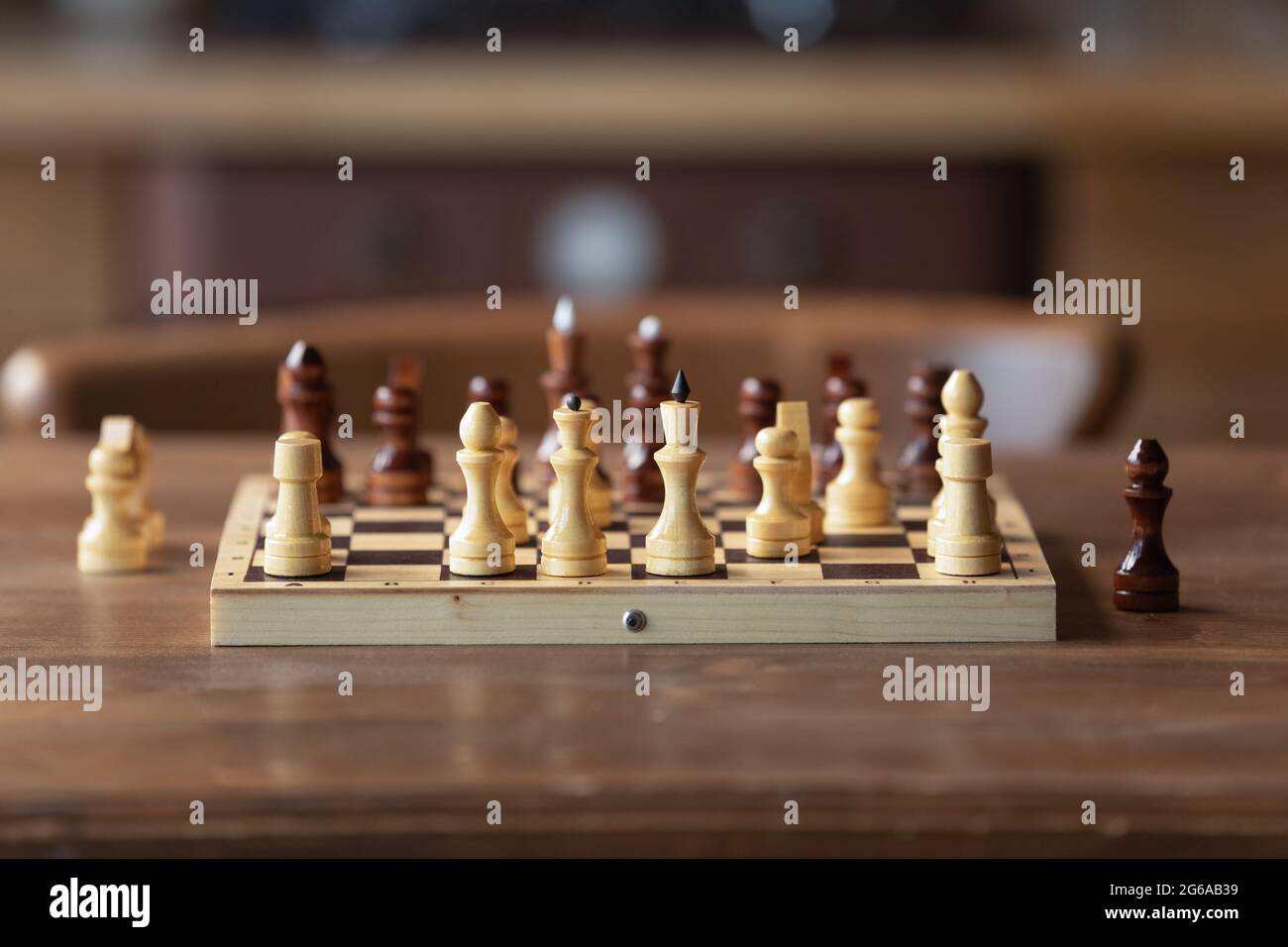 Chessboard on table in game process. Board with chess pieces Stock Photo