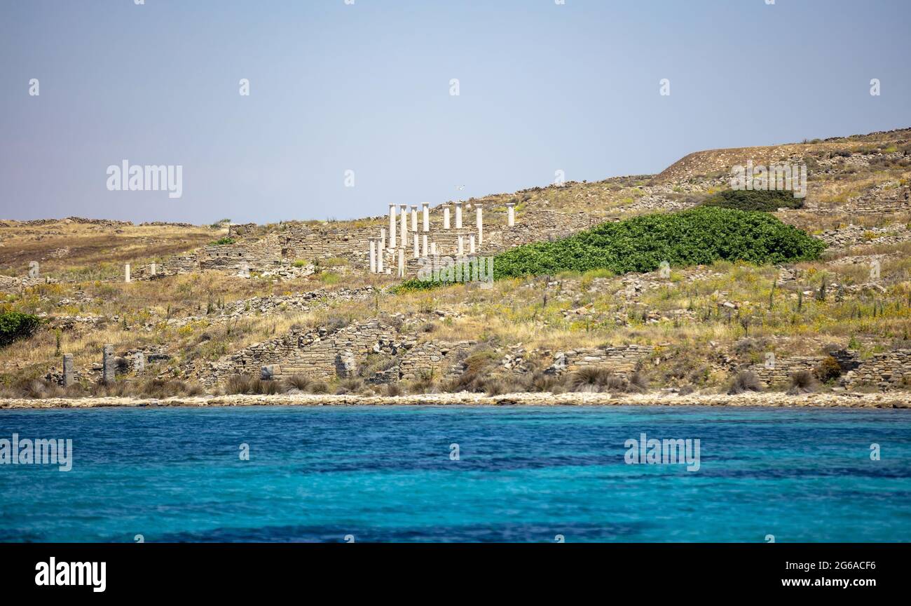 Greece. Delos Cyclades island, Stone walls and marble pillars ruins, approaching by boat view. Holy sanctuary archaeological site, UNESCO Heritage mon Stock Photo