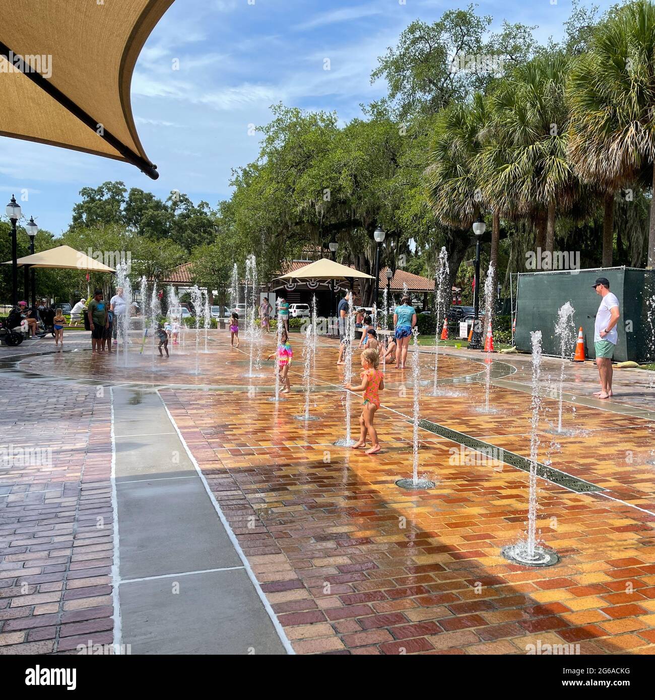 Orlando, FL USA June 23, 2021 Children playing in a fountain in