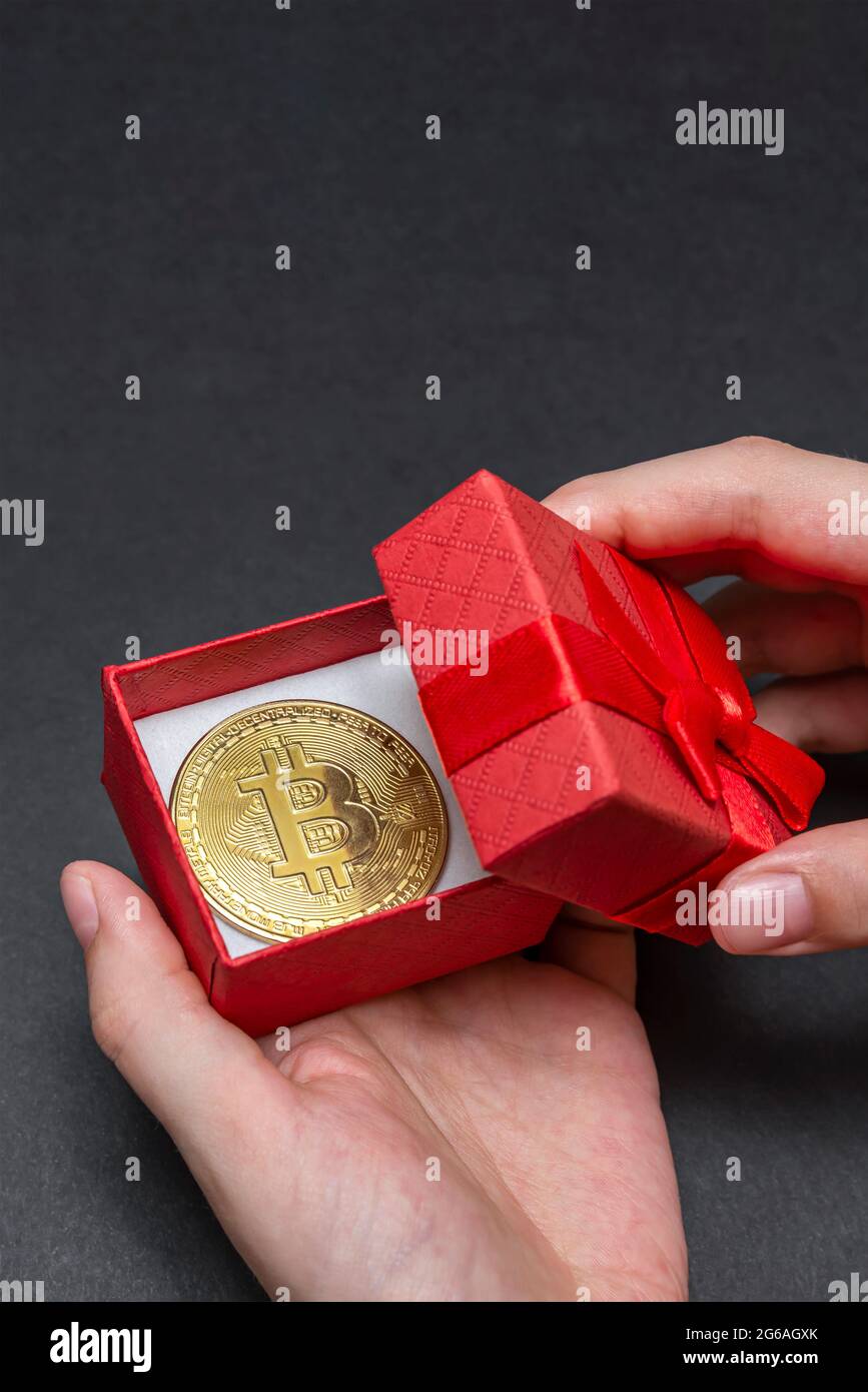 Bitcoin coin in a red gift box. christmas and new year gift. Hands open gift  box with bitcoin coin, banner Stock Photo - Alamy