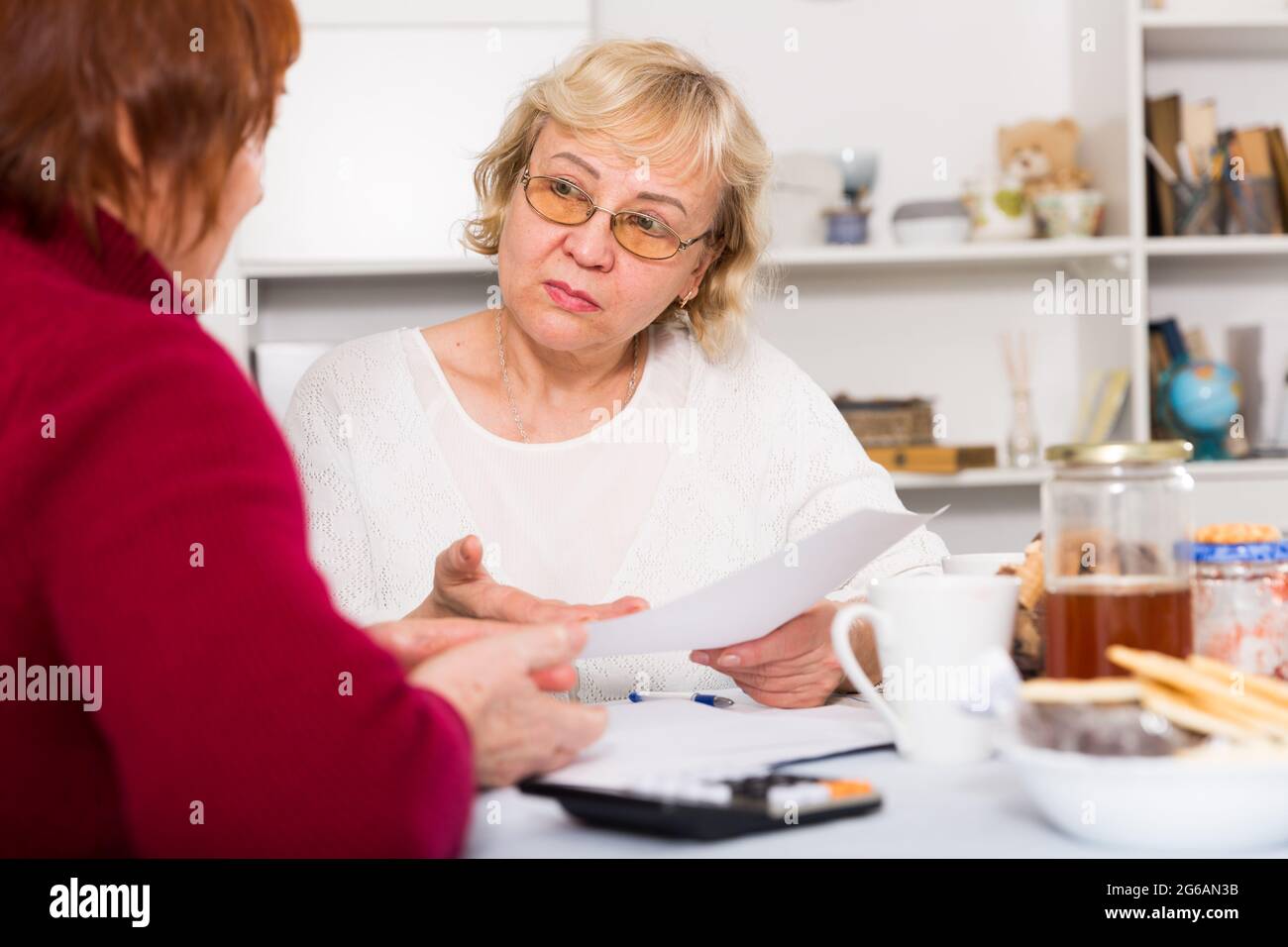 Serious old women with public utilities Stock Photo