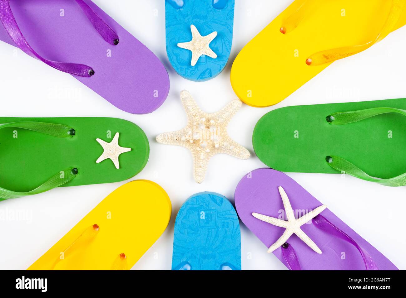 three pairs of beach rubber flip flops on a white background, view from ...