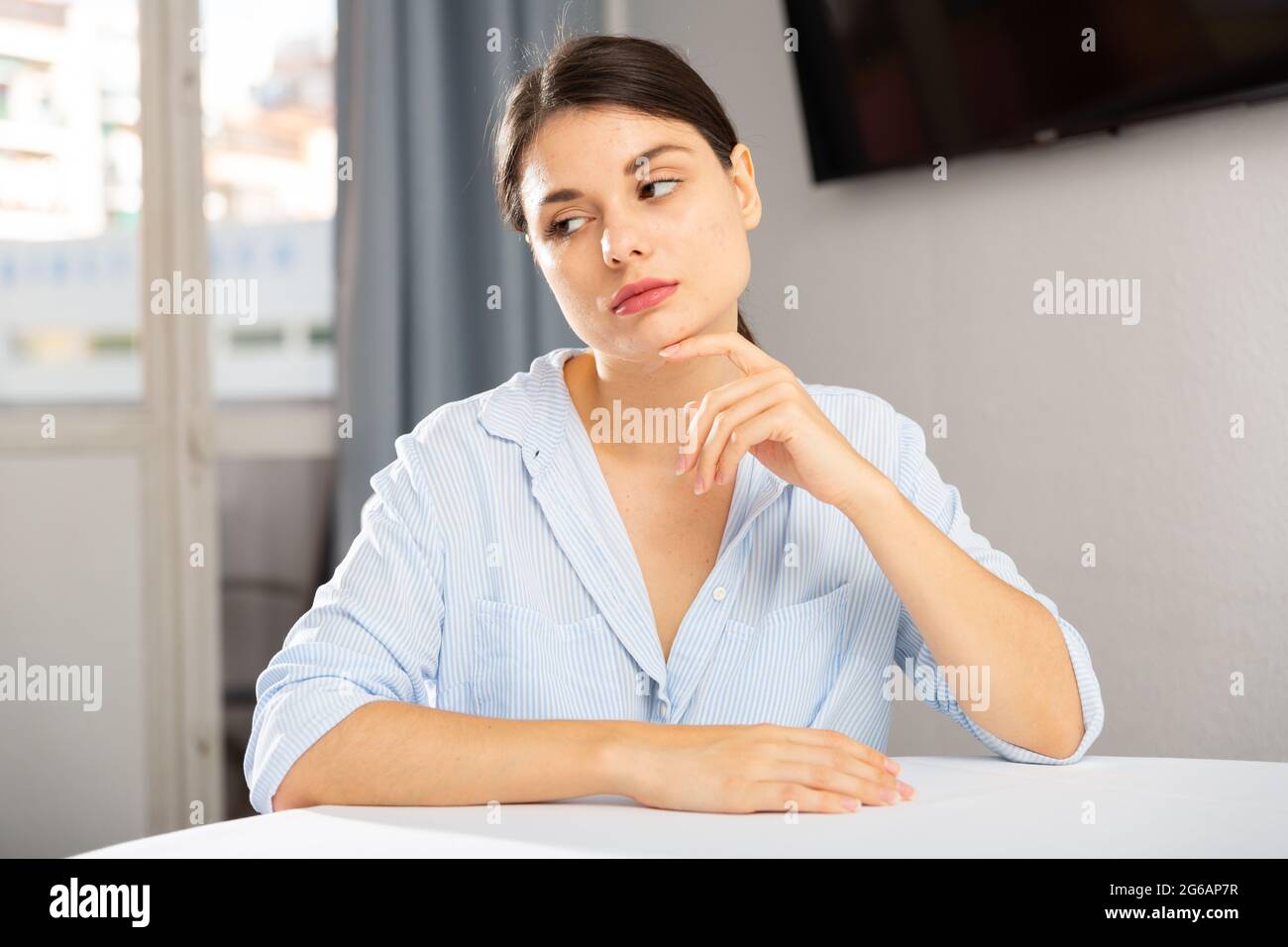 Portrait of sad girl sitting in living room at home Stock Photo - Alamy