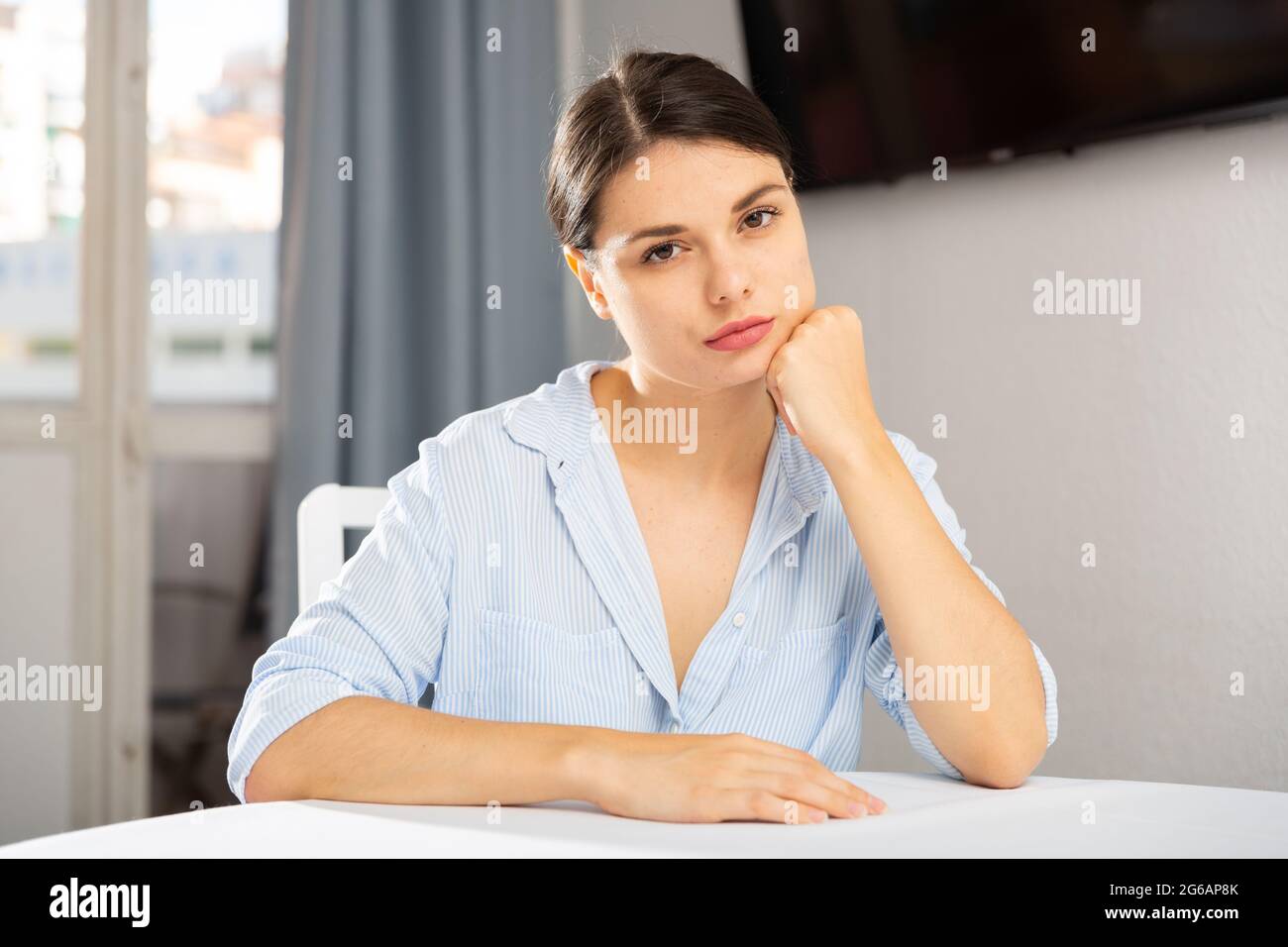 Portrait of sad girl sitting in living room at home Stock Photo - Alamy