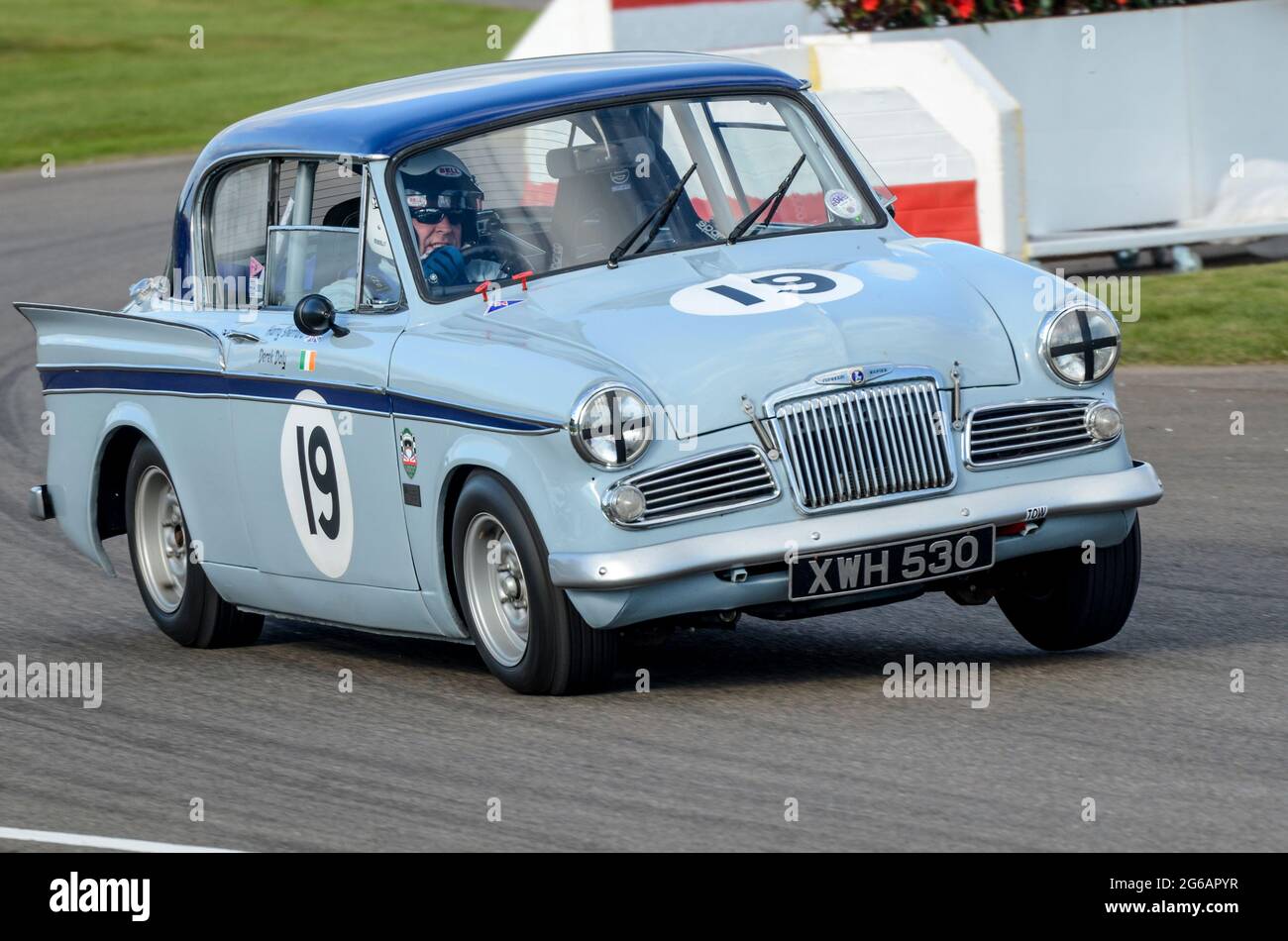 Sunbeam Rapier classic saloon, vintage racing car competing in the St Marys Trophy at the Goodwood Revival historic event, UK. Wheel up cornering Stock Photo