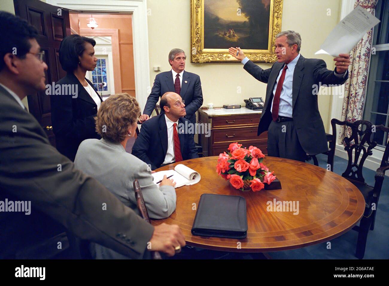 Working with his senior staff, President George W. Bush reviews the speech that he will deliver to the nation the evening of Tuesday, Sept. 11, 2001, from the Oval Office. Pictured from left are: Alberto Gonzales, White House Counsel; Condoleezza Rice, National Security Adviser; Karen Hughes, Counselor; Ari Fleischer, Press Secretary, and Andy Card, Chief of Staff.  Photo by Paul Morse, The White House. Stock Photo