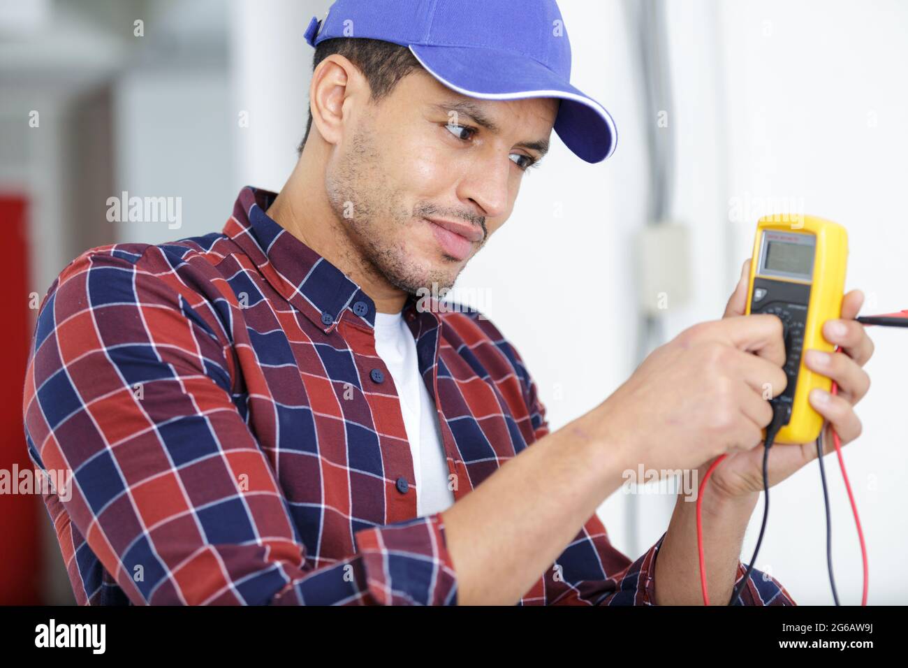 electrician testing socket with multimeter Stock Photo Alamy