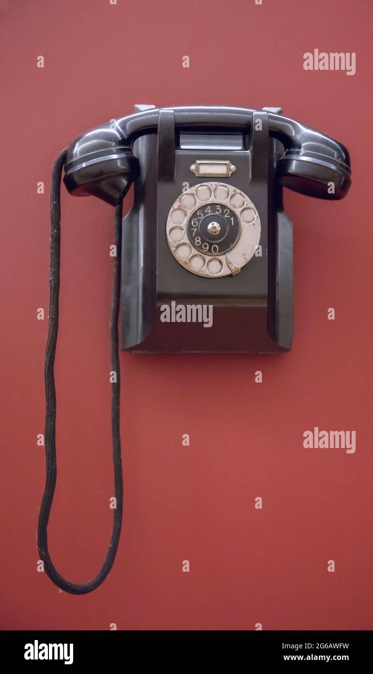 Retro wall telephone on red background Stock Photo