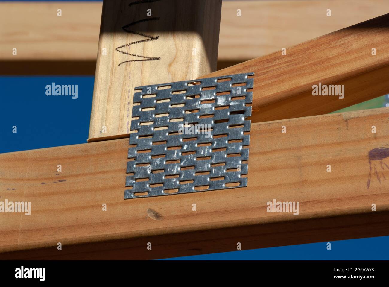 Gang nail on a timber angled roof joist Stock Photo Alamy