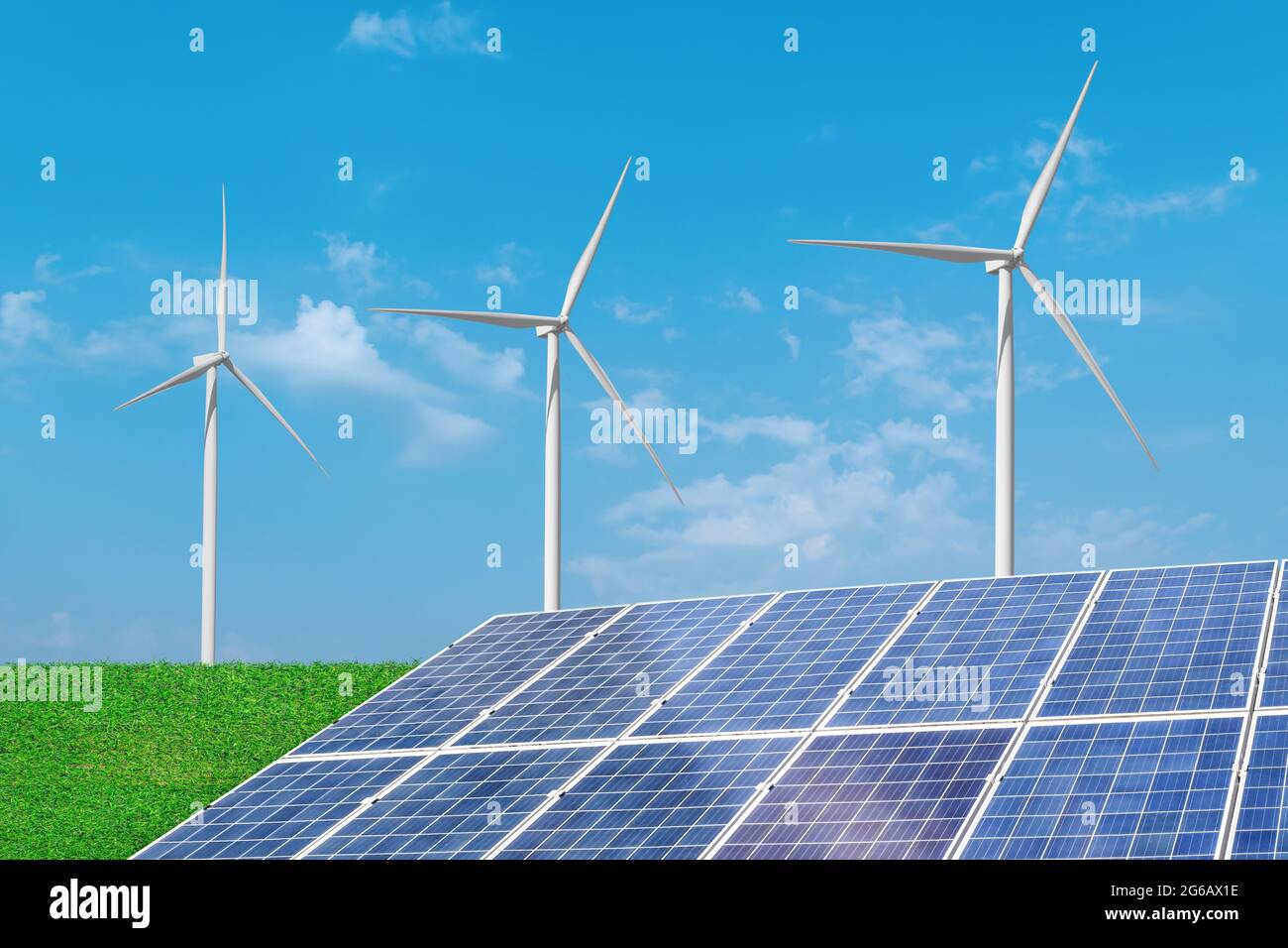 Solar panels with wind turbines generating electricity over blue sky