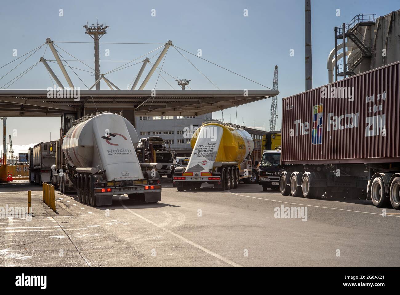 Cement carrier trucks and container trucks at the main gate Ports of Auckland. Stock Photo