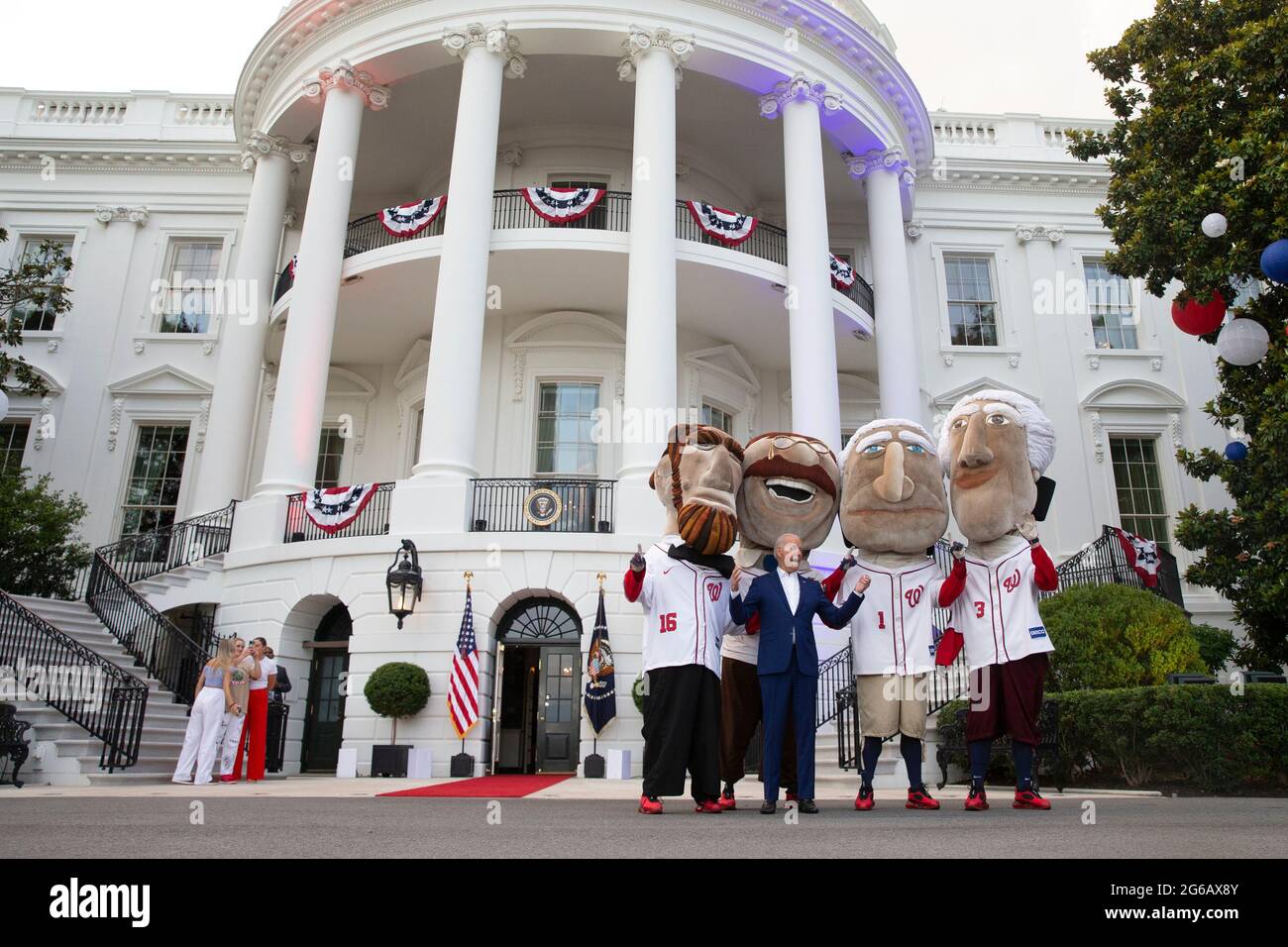 Washington, United States. 04th July, 2021. President Joe Biden poses with  people dressed as former US presidents wearing Washington Nationals  baseball uniforms on the South Lawn of the White House during an