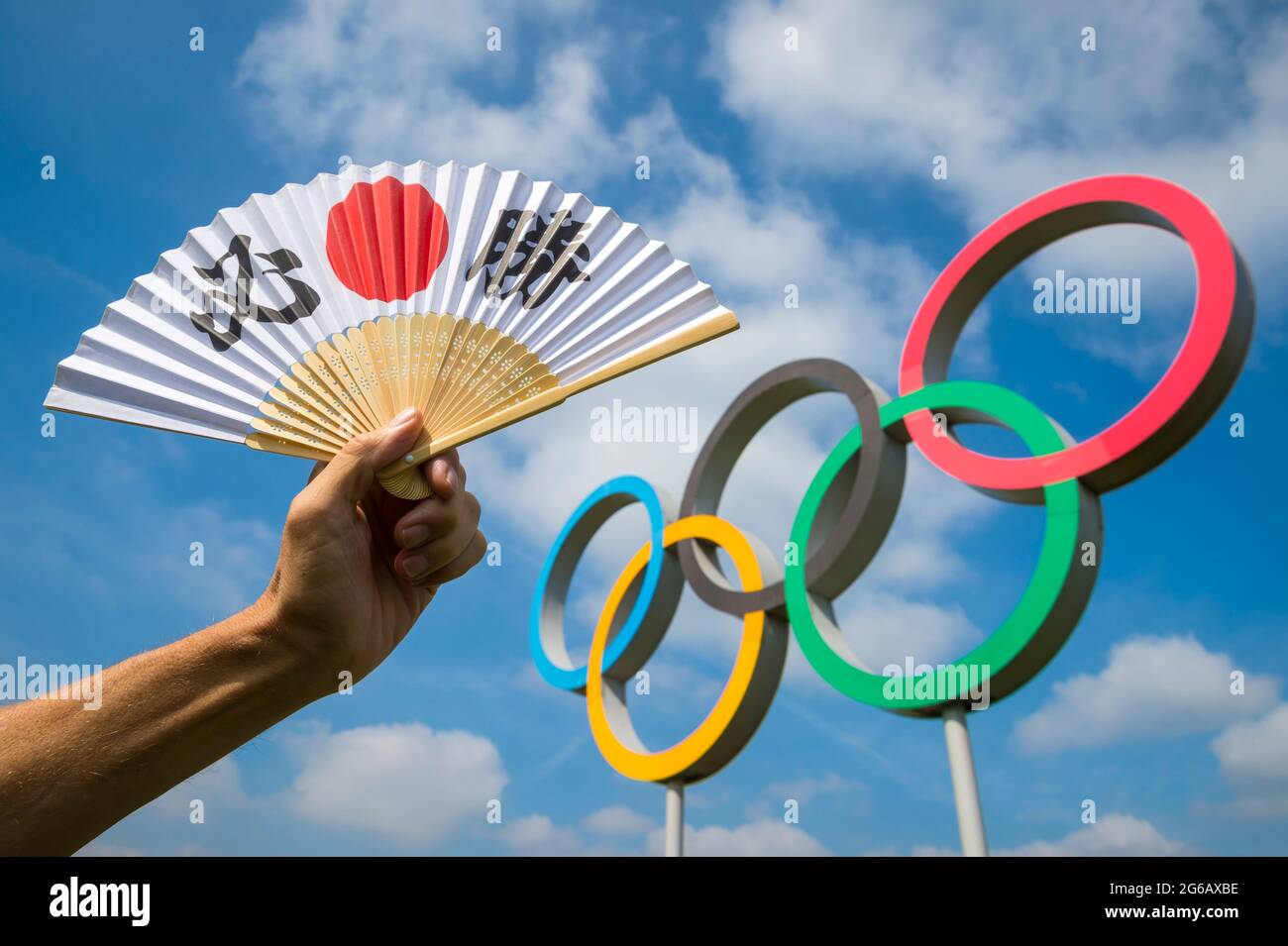 RIO DE JANEIRO - MARCH, 2016: Hand holding a fan decorated with Japanese kanji characters spelling out hissho (English translation: certain victory) i Stock Photo